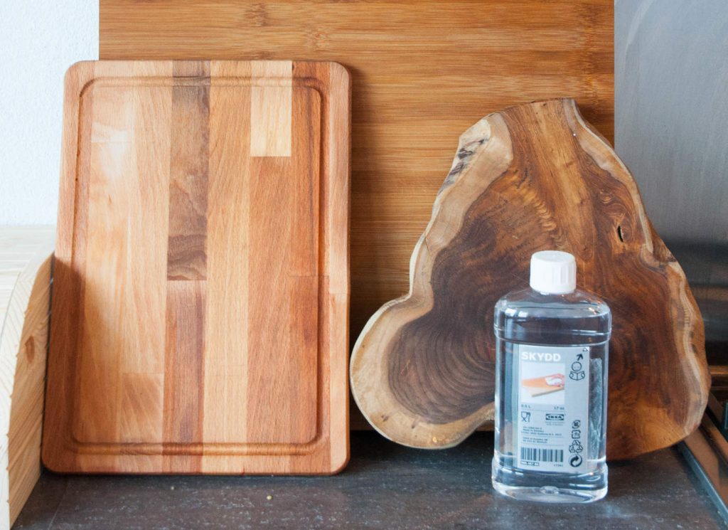 A photo of cutting boards and a bottle of wood oil. First Kitchen Essentials for Your New Apartment